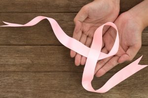 breast cancer ribbon held with hands