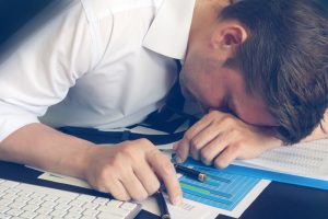 man asleep at his desk