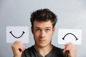 Portrait of a Person Holding Happy and Unhappy Mood Board