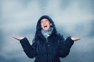 young woman is excited about the snowfall