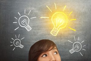 Young asian woman have idea with bright light bulb over head