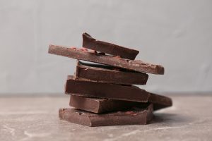 Pieces of delicious dark chocolate on table