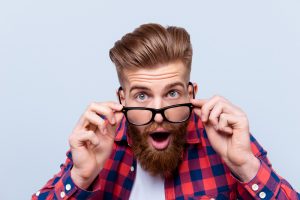 Close up portrait of shocked amazed man in checkered shirt touch