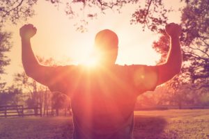 Man stands with arms raised